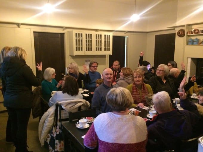 Group of people at a community event discussing BSL (Scotland) Act 2015.
