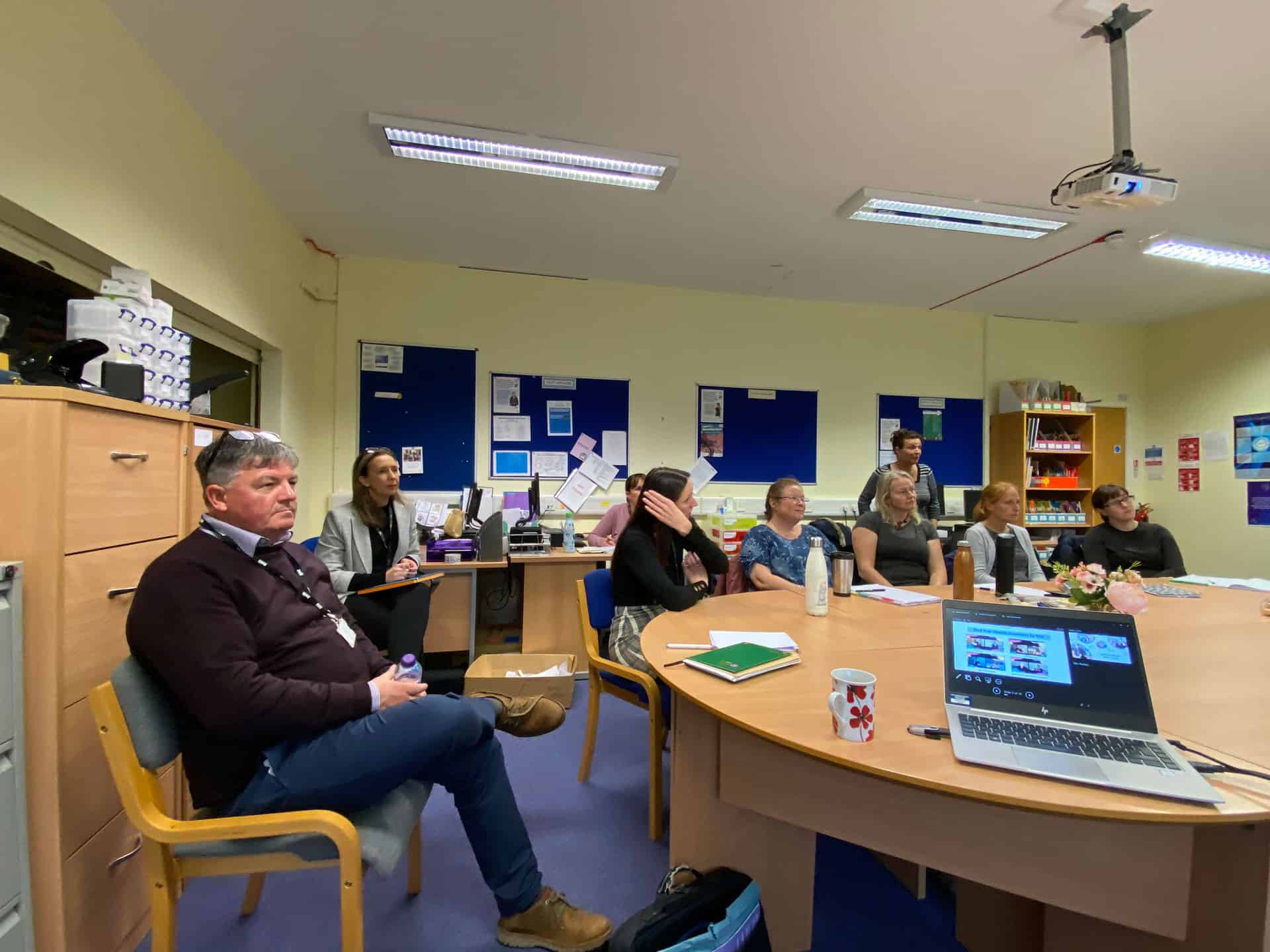 Group of people in a classroom discussing BSL (Scotland) Act 2015.