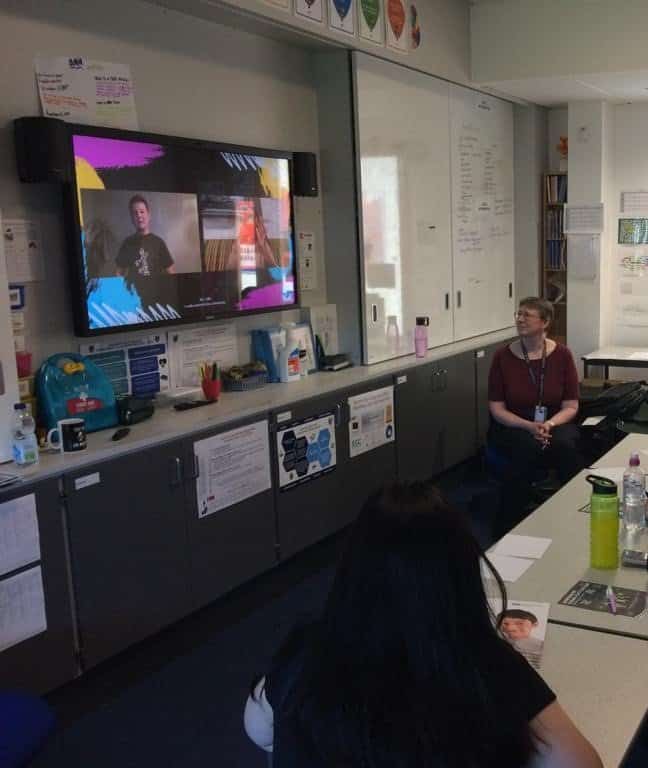 Sign language interpreter presenting at BSL Scotland Act 2015 event in a classroom.