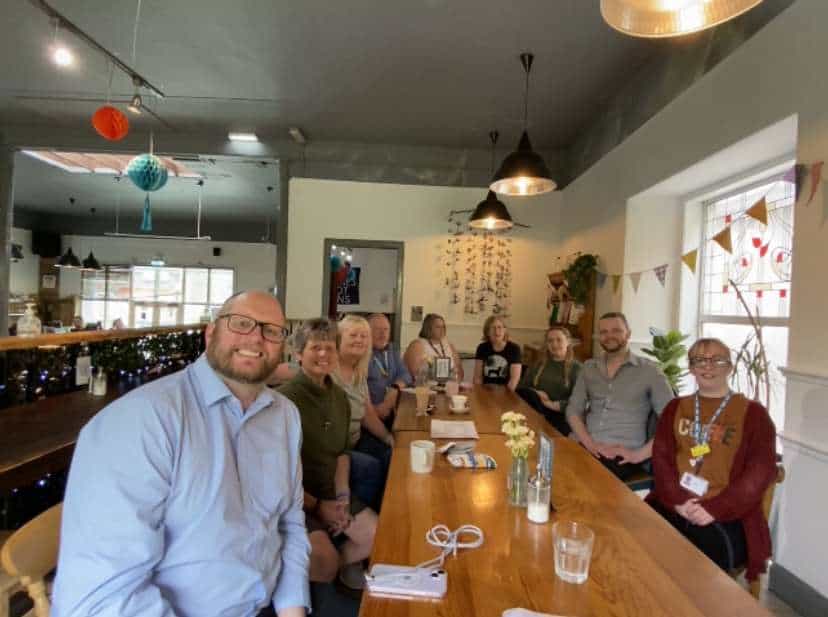 Group of people at a meeting discussing BSL (Scotland) Act 2015.