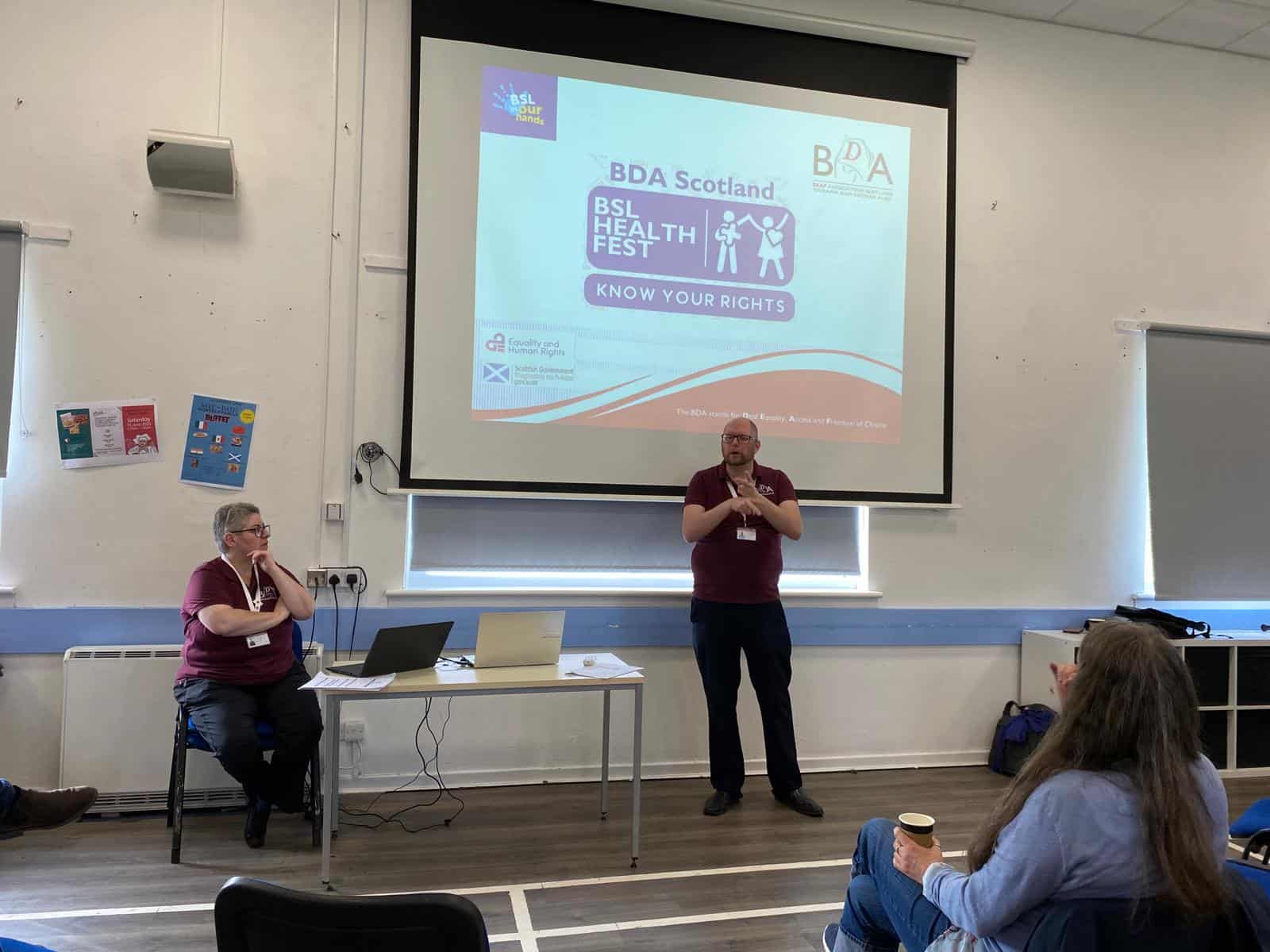Speaker presenting at BDA Scotland Health Fest on rights and health.