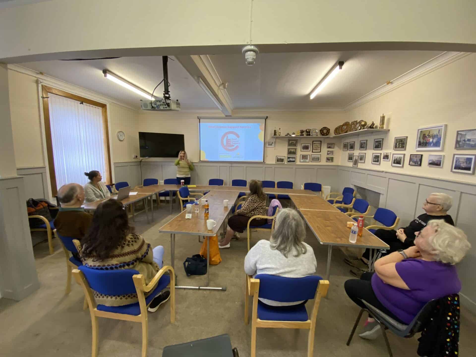 People attending a BSL Act 2015 awareness session in a community hall.