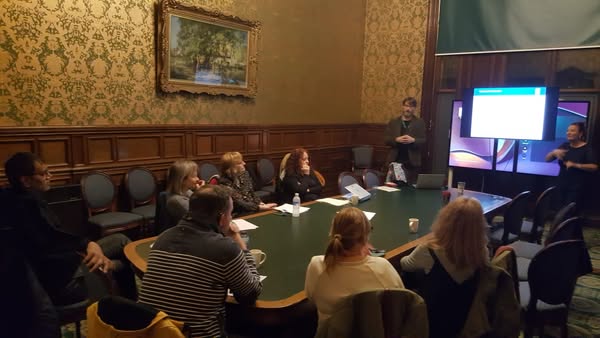 People attending a BSL Act 2015 awareness session in a historic room.