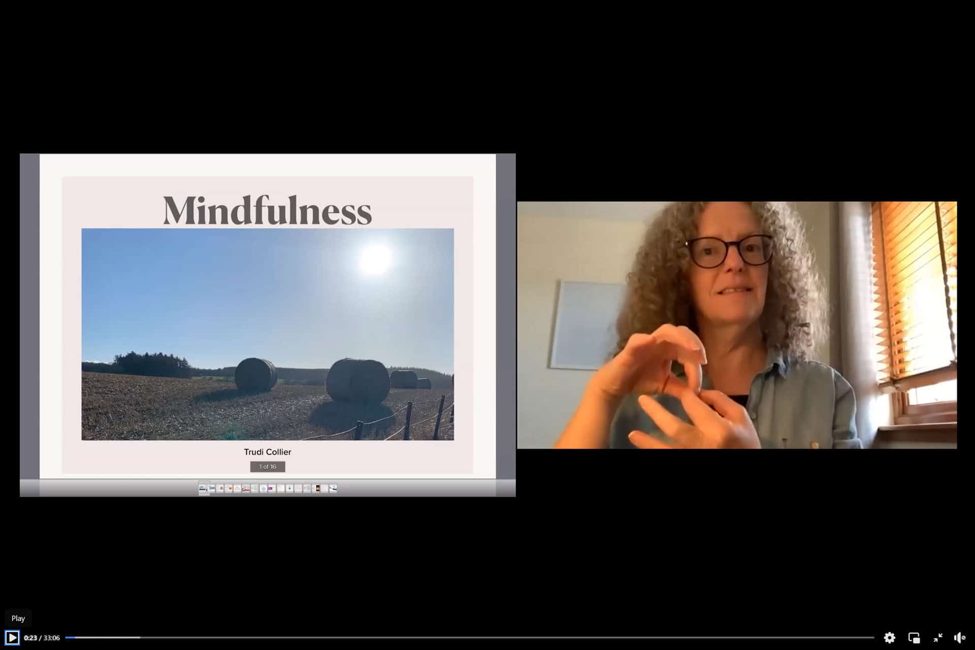 Woman teaching sign language during mindfulness session in a virtual workshop.