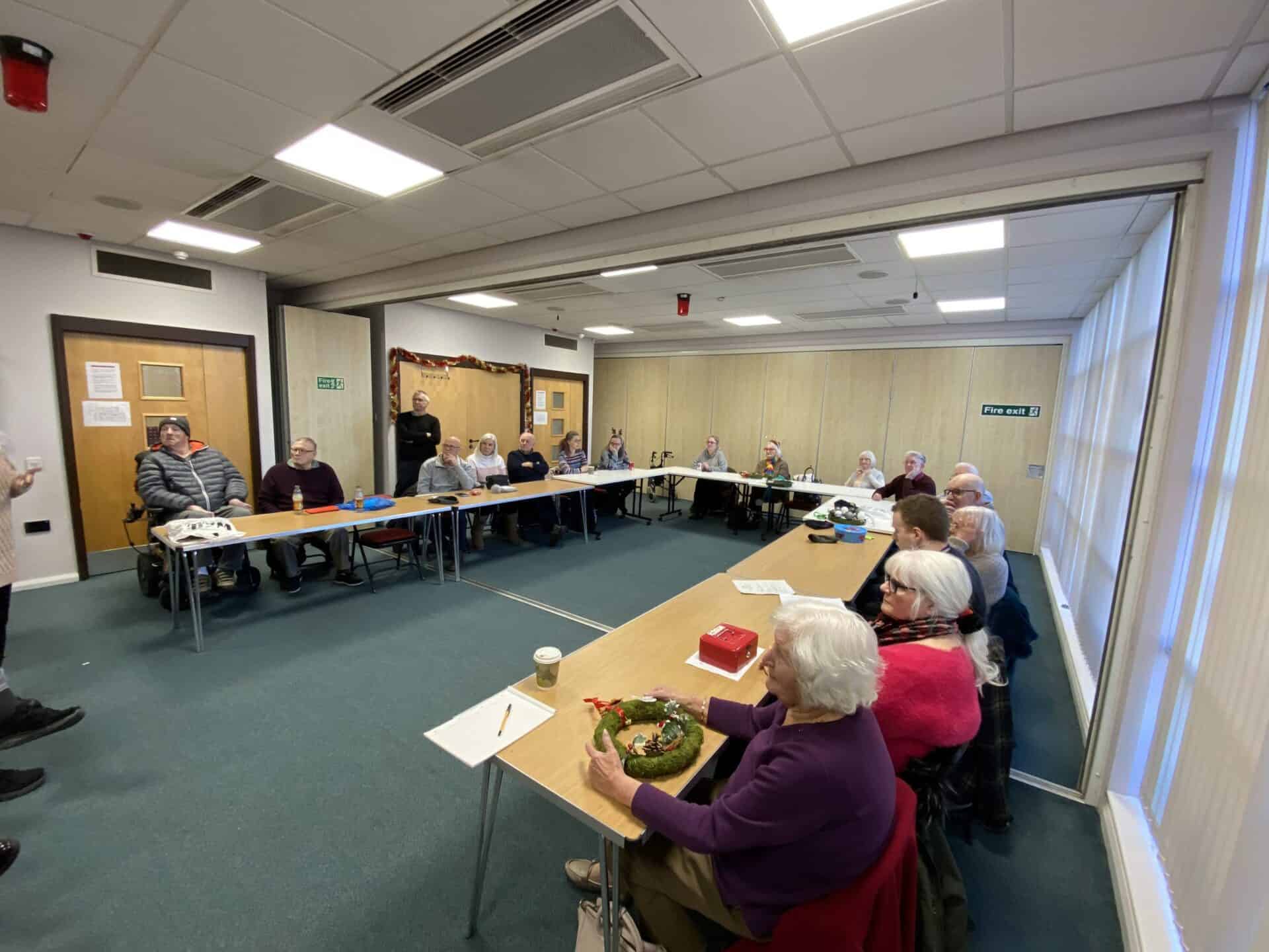 Deaf community meeting discussing the BSL (Scotland) Act 2015 in a conference room.