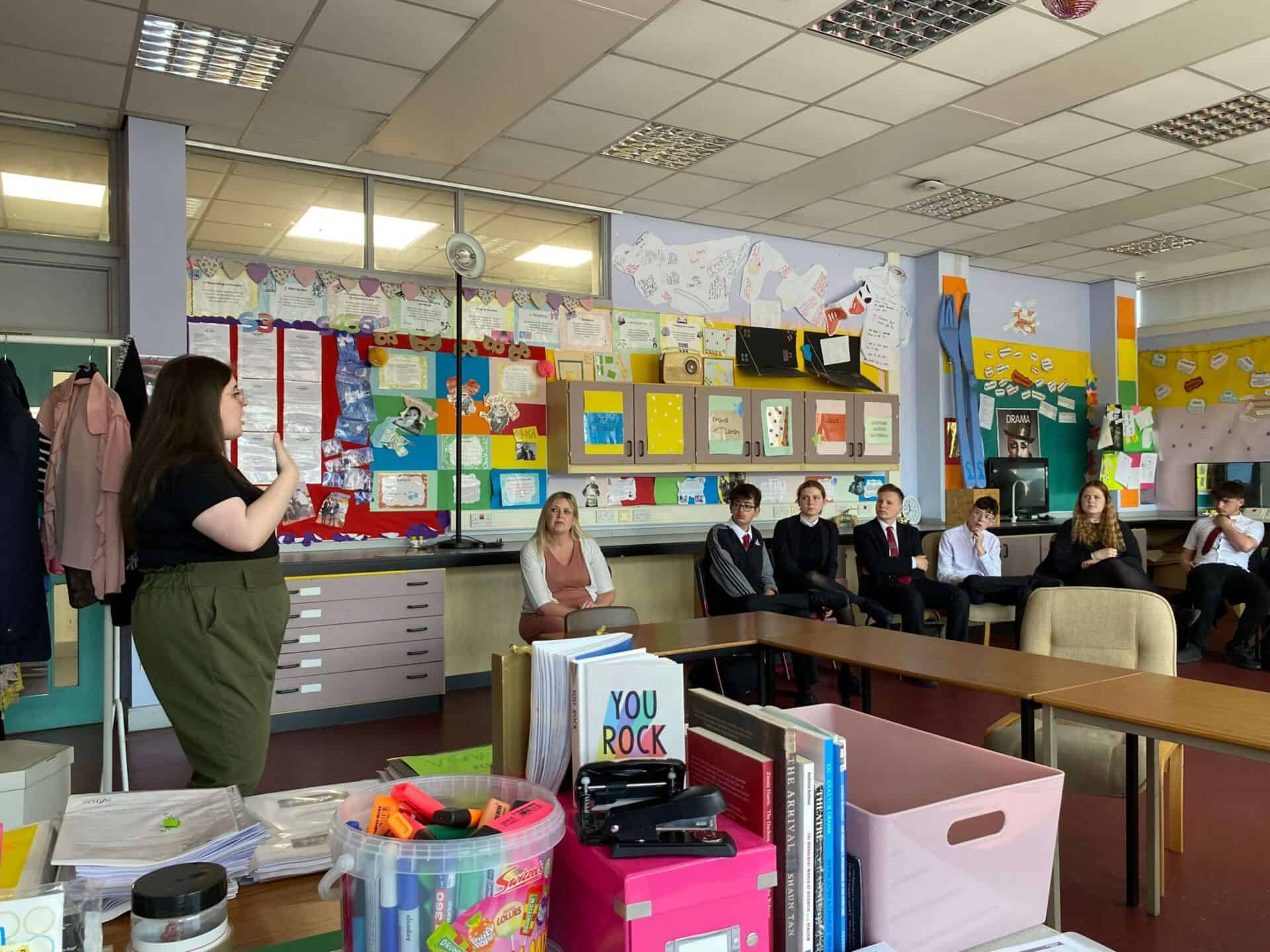 Sign language interpreter speaking at a classroom event about the BSL Act 2015.