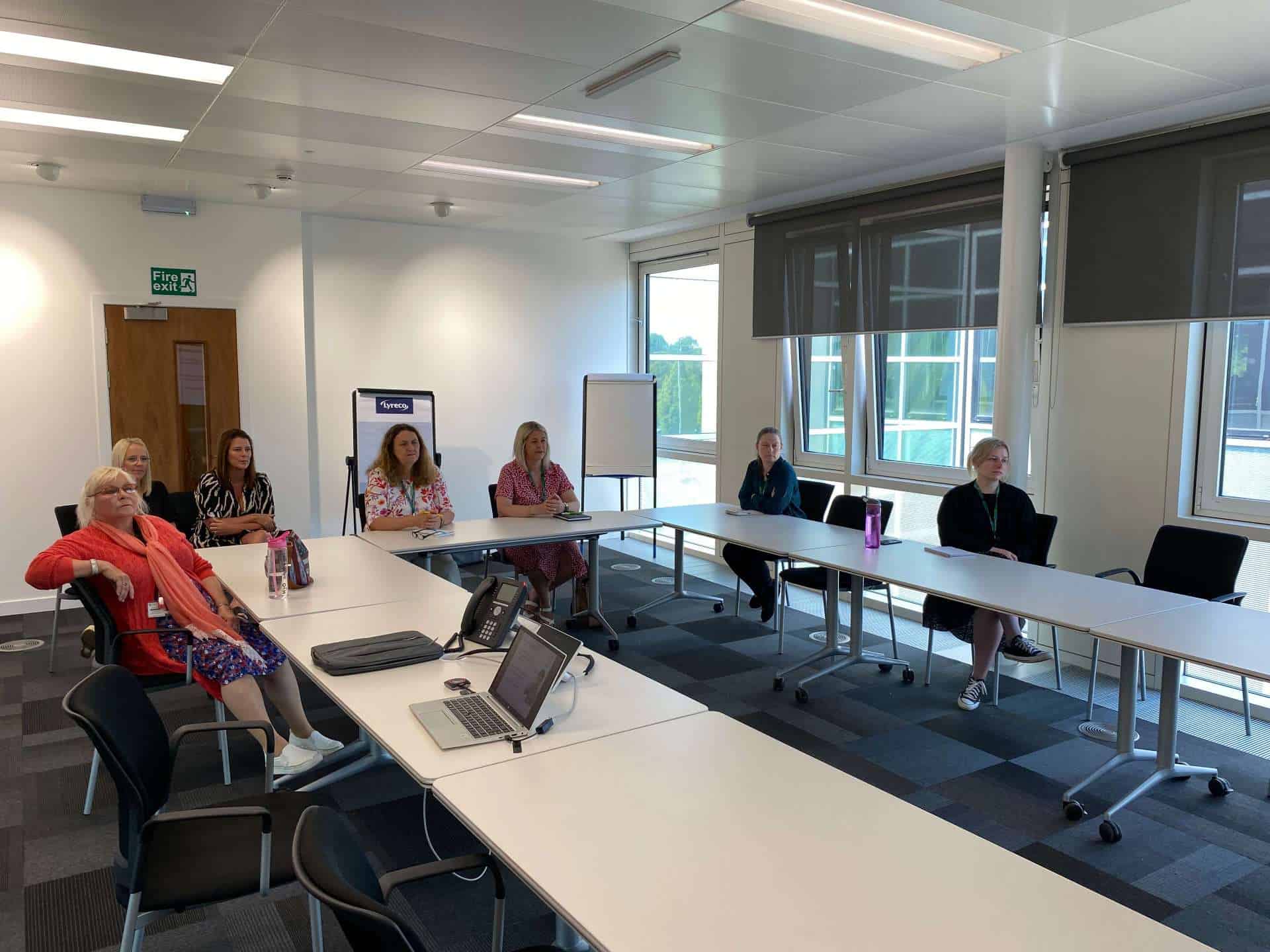 People attending a meeting about the BSL (Scotland) Act 2015 in a conference room.