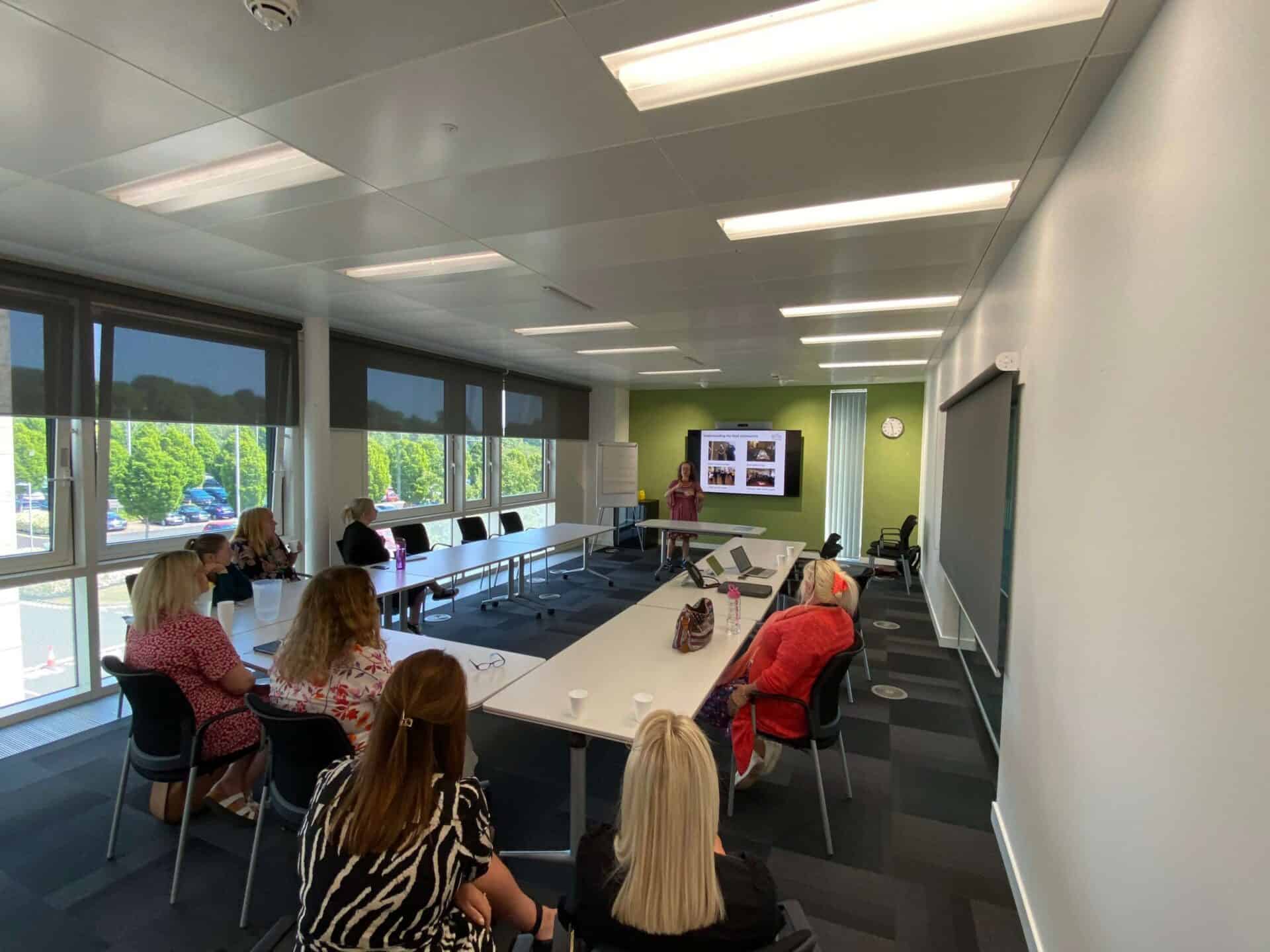 Group of people attending a BSL Act 2015 seminar in a modern conference room.